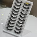 Set of false eyelashes in a packaging tray on a white surface