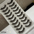 Set of false eyelashes on a white tray with a reflective surface.