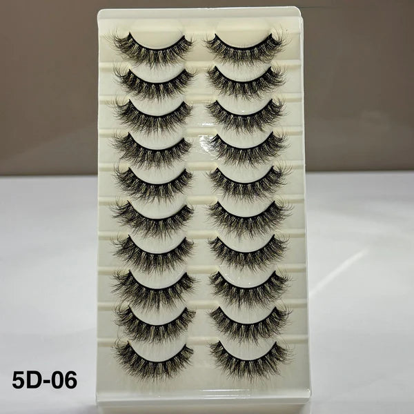 Set of false eyelashes in a white box with a beige background