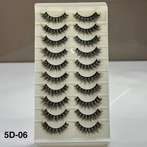 Set of false eyelashes in a white box with a beige background