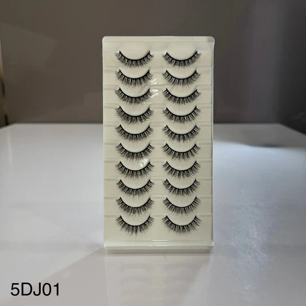 Set of false eyelashes on a white card with a gray background