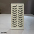Set of false eyelashes on a clear plastic card with a white background
