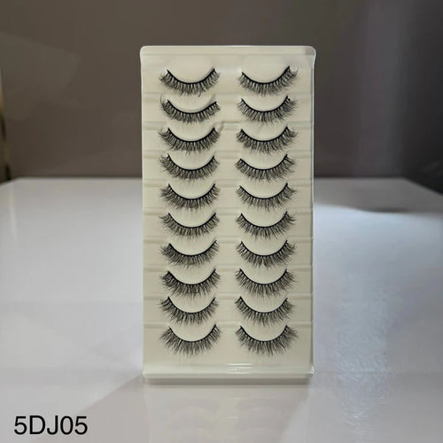 Set of false eyelashes on a clear plastic card with a white background