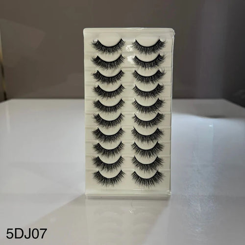 Set of false eyelashes in a box on a reflective surface with a neutral background