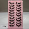 Pink tray with false eyelashes labeled KZ03 on a gray background