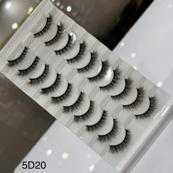 Set of false eyelashes on a white tray with a blurred background