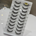 Set of false eyelashes on a gray packaging with a marble pattern.