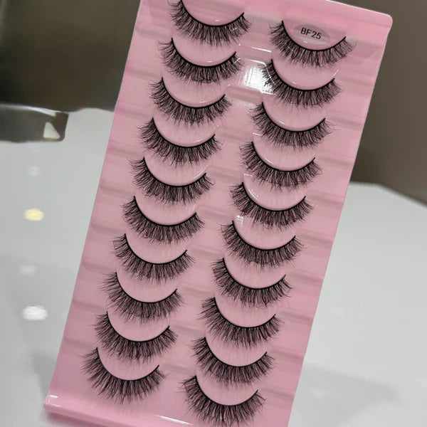 Set of false eyelashes on a pink tray with a blurred background