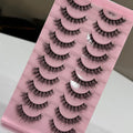 Set of false eyelashes on a pink packaging with visible brand name.