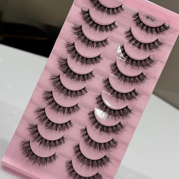 Set of false eyelashes on a pink packaging with visible brand name.