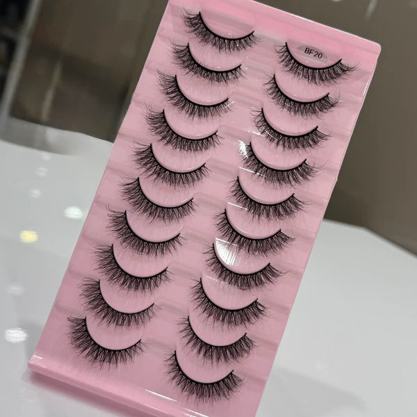 Set of false eyelashes on a pink packaging with a blurred background