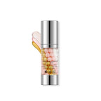 Skincare serum bottle with colorful droplets on a white background