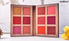 Makeup palette with various shades of pink and red on a light background