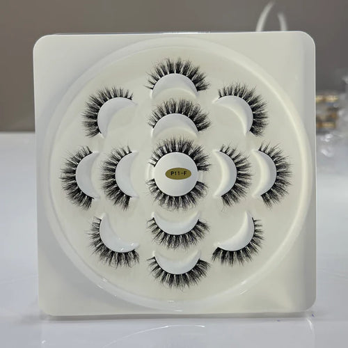 Set of false eyelashes in a white container with a brand logo.