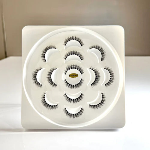 Set of false eyelashes on a white tray with a neutral background