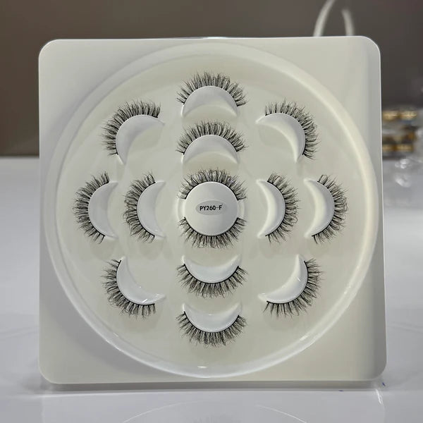 Set of false eyelashes on a white tray with a blurred background