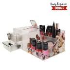 Clear acrylic beauty organizer with makeup items on a white background