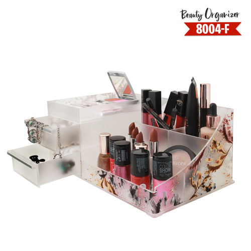 Clear acrylic beauty organizer with makeup items on a white background