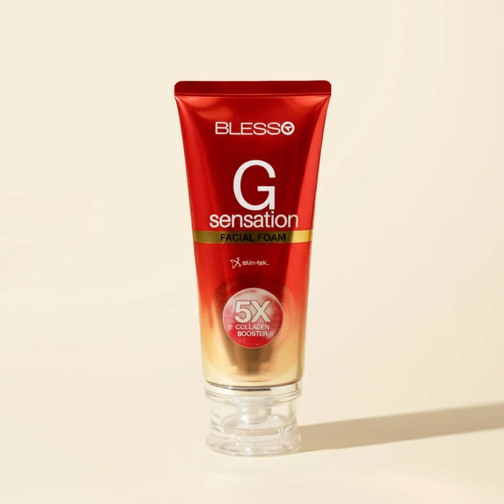 Blesso G Sensation Facial Foam in a red squeeze tube with a clear cap, set against a warm beige background.