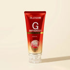 Blesso G Sensation Facial Foam in a red squeeze tube with a clear cap, set against a warm beige background.