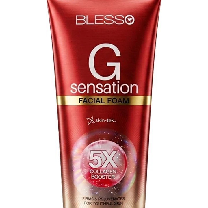 A red squeeze tube of Blesso G Sensation Facial Foam with gold and white text, featuring a skin-tec logo and a 5X collagen booster graphic, on a white background.