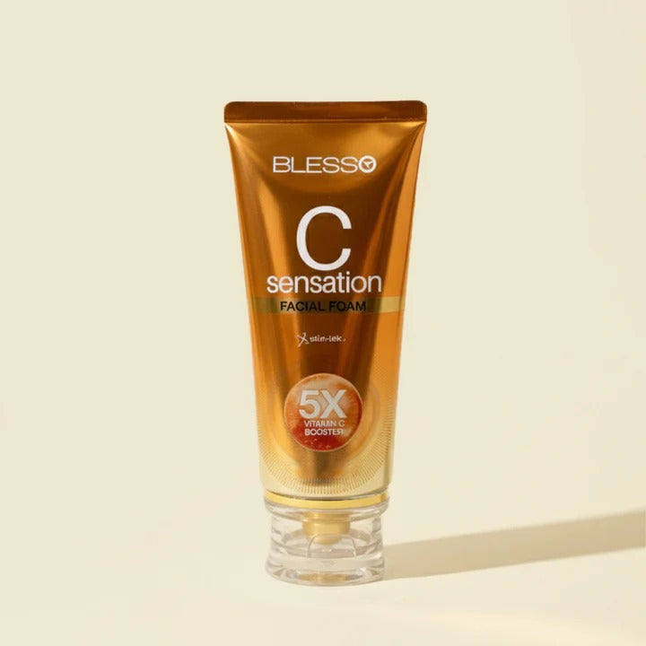 Blesso C Sensation Facial Foam in a metallic gold squeeze tube with a clear cap, set against a solid cream background.