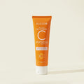 Orange tube of Blesso Vitamin C brightening cleanser on a beige background