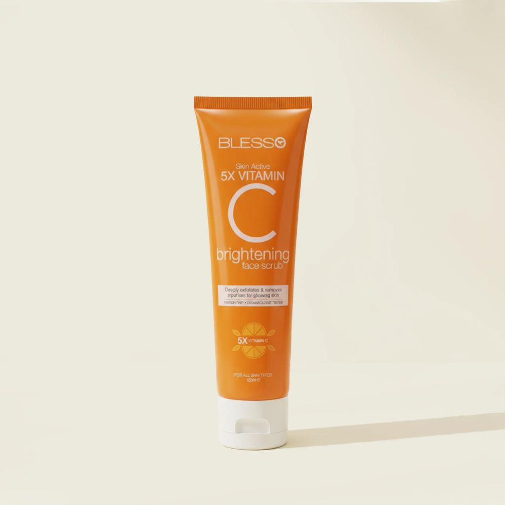 Orange tube of Blesso brightening face scrub on a beige background