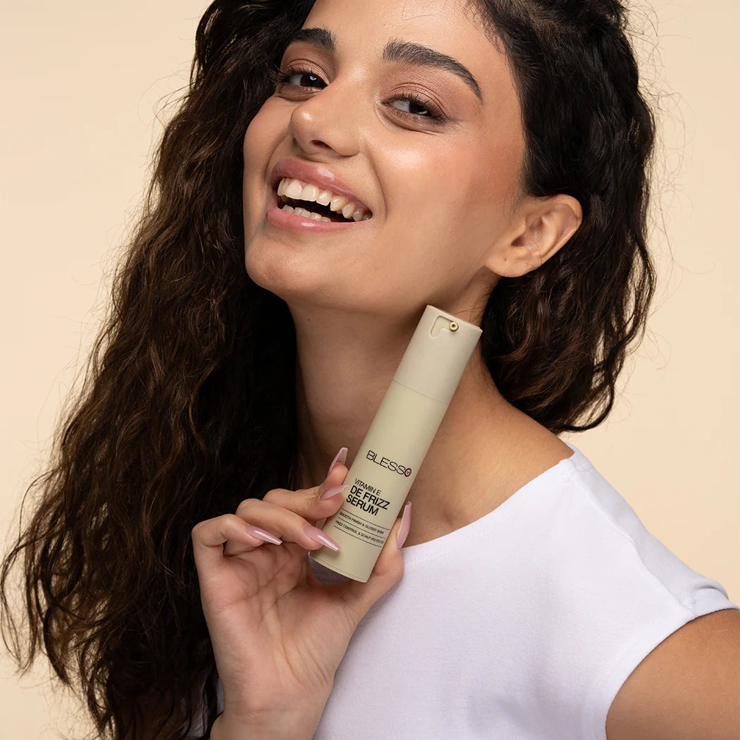 Woman holding a Blesso skincare product with a beige background