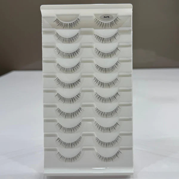 Set of false eyelashes on a white tray with a neutral background