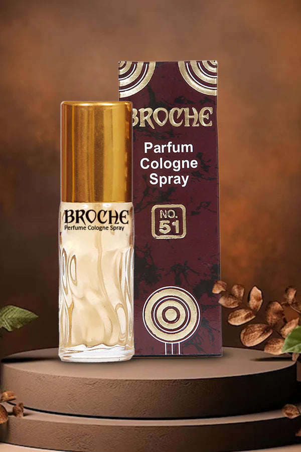 Broche perfume cologne spray bottle and packaging on a brown background