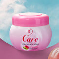 Pink jar of Care Vanishing Cream with a pink lid on a blue and pink gradient background.
