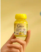 Hand holding a yellow bottle of Caresse Easy Clean against a yellow background