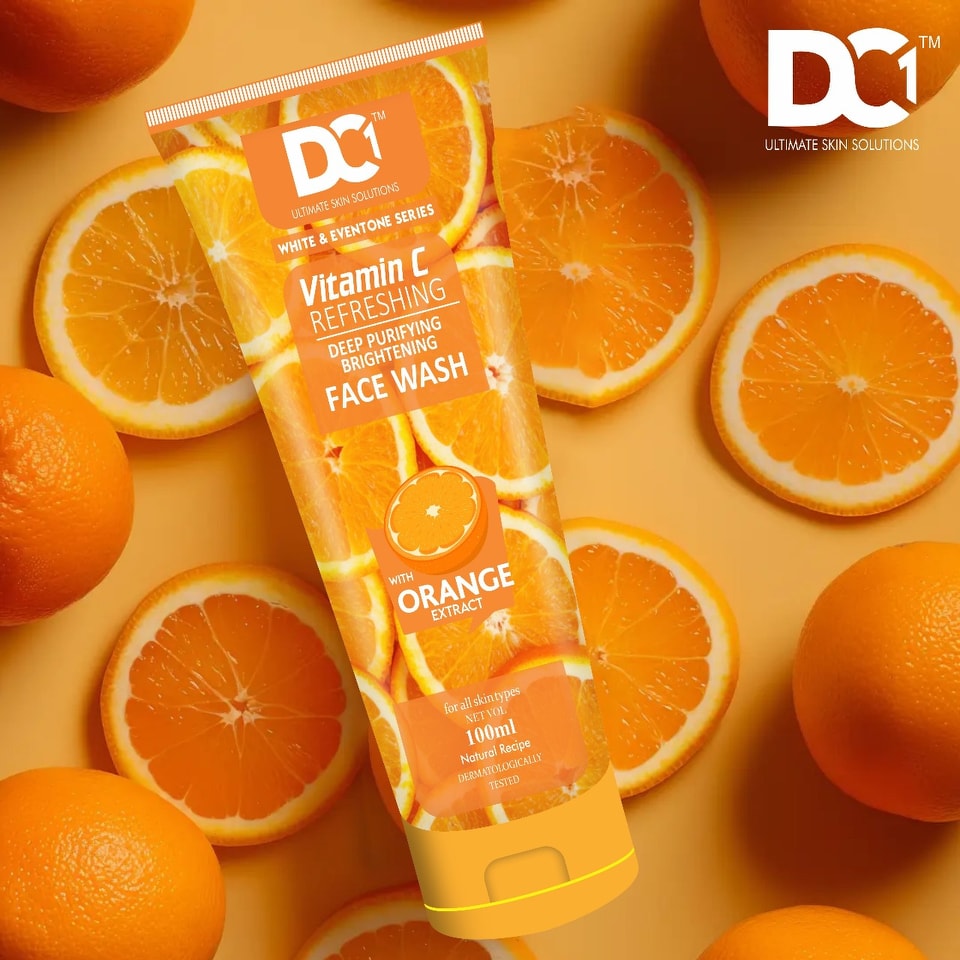 Tube of DC Vitamin C Face Wash surrounded by oranges on a yellow background