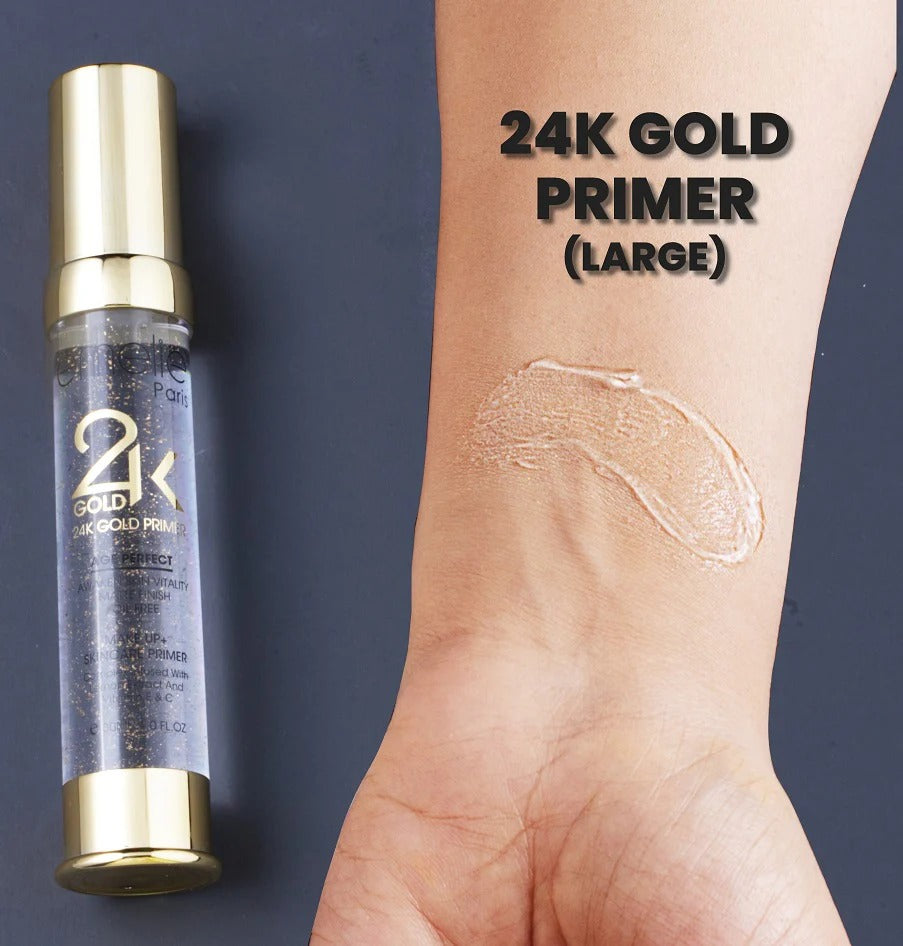 Emelie Paris 24K Gold Primer bottle with a swatch on a wrist against a dark background