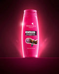 Pink shampoo bottle labeled 'Fresh'n'Joy' on a dark red background