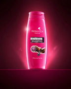 Pink shampoo bottle labeled 'Fresh'n'Joy' on a dark red background