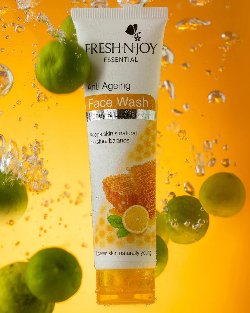 Fresh-N-Joy Anti-Ageing Face Wash tube with honeycomb and lemon graphics on a yellow background with green fruits.