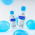 Two bottles of FreshnJoy Pure Glycerine on a light blue background with blue spherical objects.