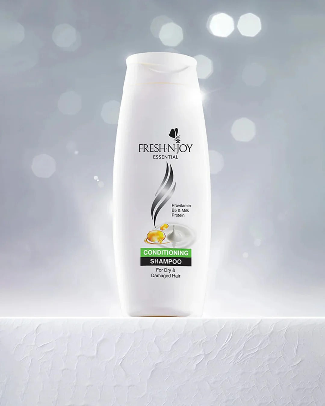 Shampoo bottle labeled 'Fresh & Joy' on a gray background