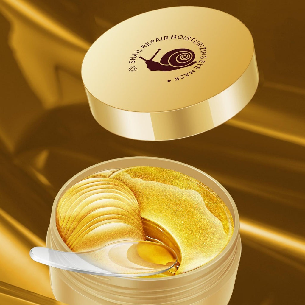 Snail repair moisturizing eye mask in a gold container with a spoon on a gold background