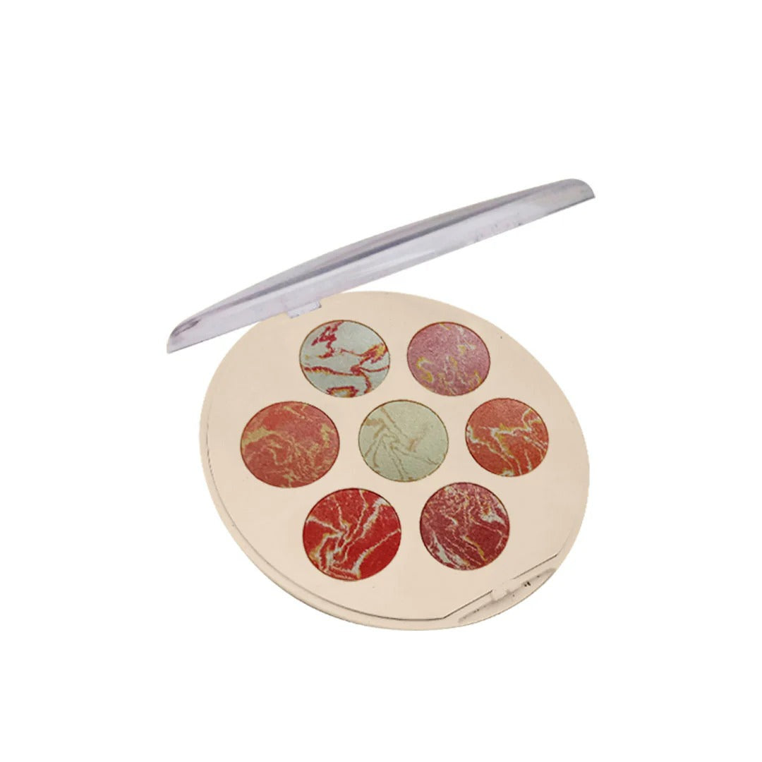 Makeup palette with marble texture and a lip liner on a white background