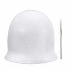 White plastic cap with small holes and a metal needle on a white background
