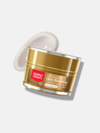 Golden Pearl Glow Boosting Cream jar with a white cream smear on a light beige background