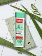 Golden Pearl moisturizing cleansing milk bottle with aloe vera on a tiled background