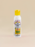 Bottle of Golden Girl Cleansing Milk on a beige background