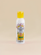 Bottle of Golden Girl Cleansing Milk on a beige background