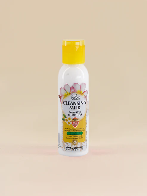 Bottle of Golden Girl Cleansing Milk on a beige background