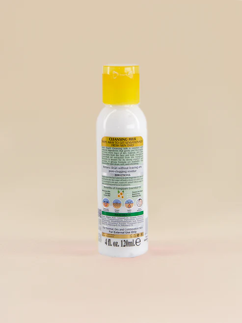 Bottle of Golden Girl Cleansing Milk with a yellow cap on a beige background