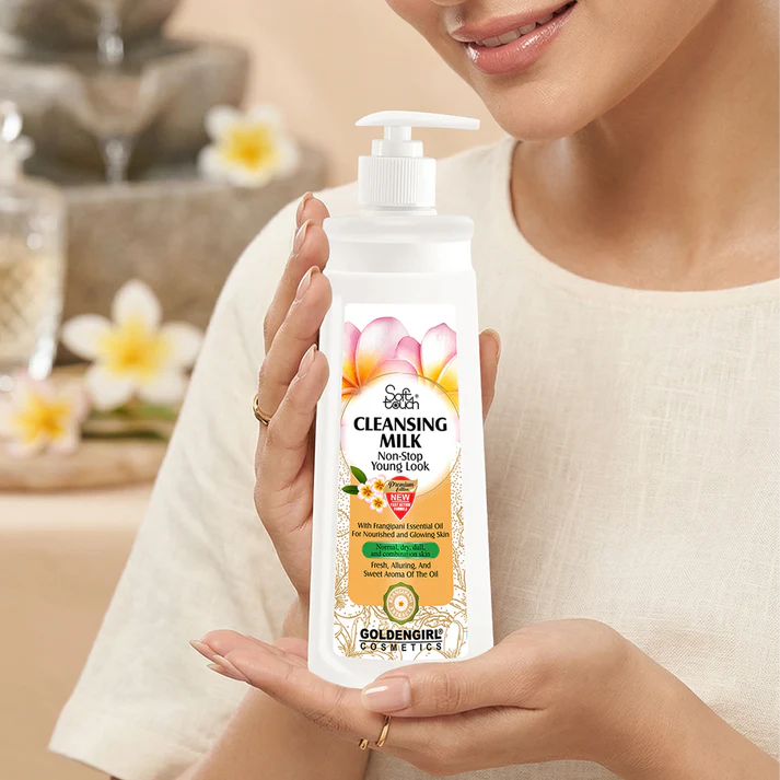 Woman holding a bottle of Golden Girl cleansing milk with a blurred background
